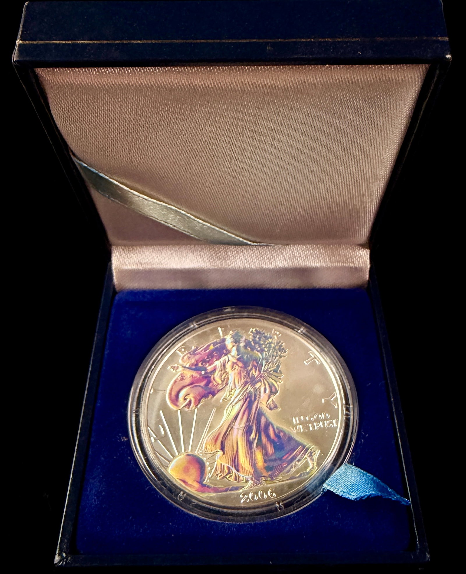 US 2006 American Silver Eagle 1 oz Fine Silver One Dollar Coin with Aftermarket Holographic Finish: A US 2006 American Silver Eagle one dollar coin struck in 1 oz of .999 fine silver. The coin features the Walking Liberty obverse and a heraldic eagle reverse. The obverse is inscribed with the charac