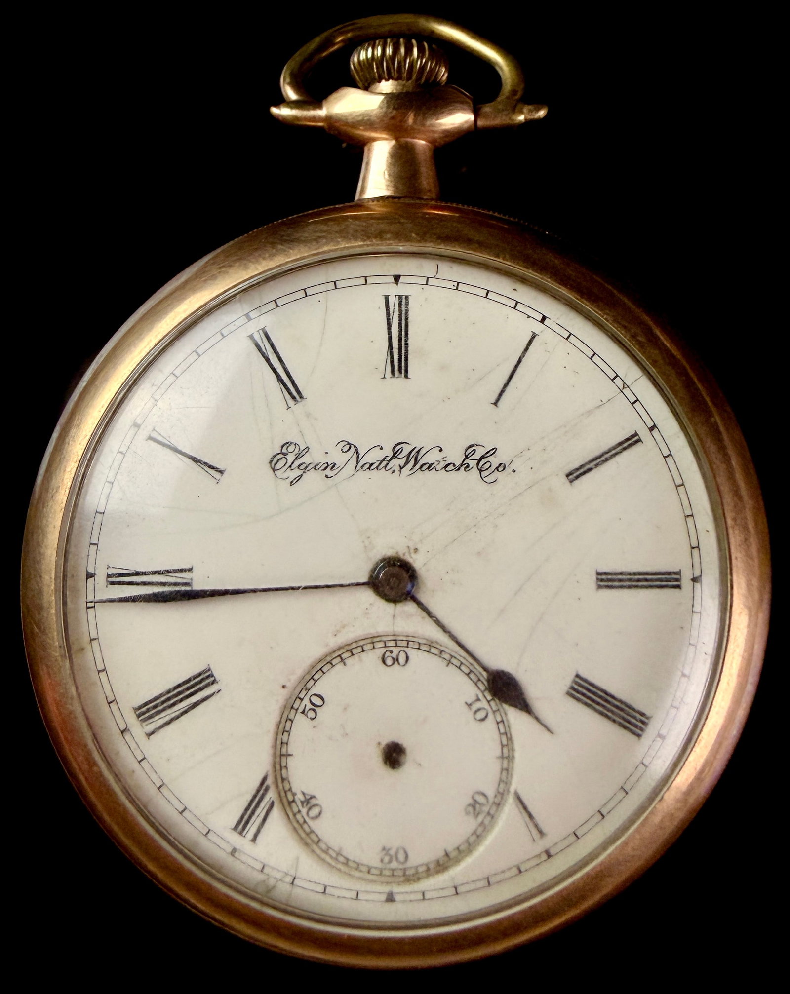 Elgin National Watch Co Grade 291 16 Size Gold Filled Pocket Watch: This is an American open-face pocket watch produced by the Elgin National Watch Co. The white porcelain enamel dial features a cursive black signature reading Elgin Natl Watch Co. It is configured wit