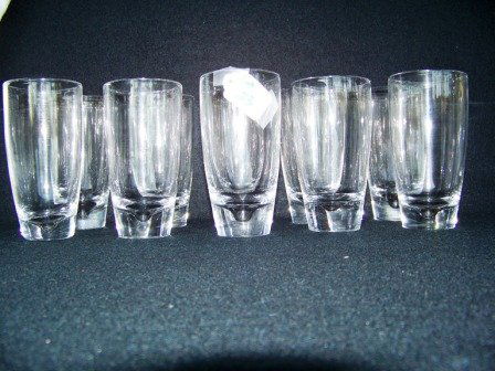 10 Signed Steuben Glasses: Set of 10 Steuben glasses measuring 5 3/8" tall with what looks like a pulled bubble in base. Base measures 2 5/8" across fits glasses 5 1/2" tall.