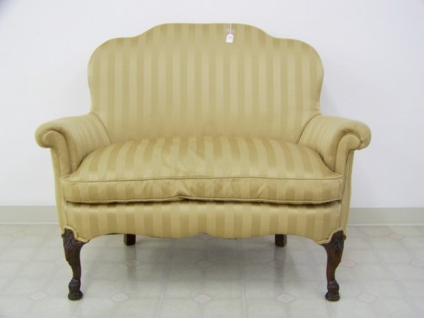 Antique Carved Downfilled Chair 1/2: Has been redone in a gold striped fabric with down filled cushion. Stands app. 39" 47 1/2" wide app 22" deep in kidney shape.