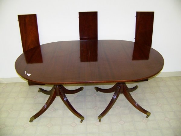 Early Duncan Phyfe Style Inlaid Banded Dining Table: Of oval form with 3 leafs and wooden leaf case. All brass capped feet with inlaid banded around outer edge . 6 foot long without the leafs each leaf is 11" wide . Stands 29 1/2" tall # F1300 & 23to ba