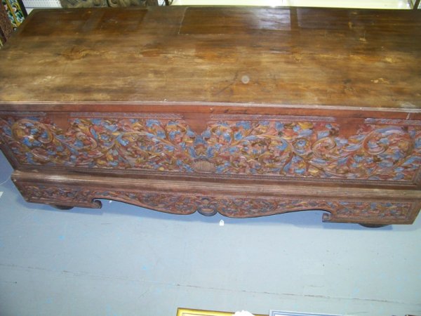 Vintage Massive Hand Carved and Painted Wood Trunk: Monumental Vintage Hand Carved and Painted Wood Trunk Chinese. Front fully carved with floral and vineage resting on four carved wheels. Massive size. 102" w x 39" d x 41" h