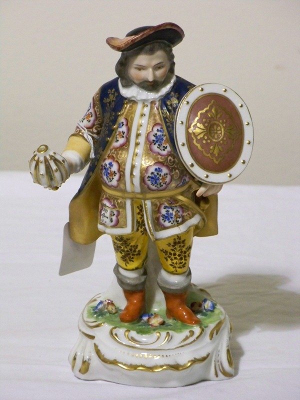 Crown Derby Porcelain Figure of Falstaff: Crown Derby porcelain figure of Falstaff, depicted with a rose colored shield, with vividly colorful clothing accented by his crimson boots, and raised on a cartouche shaped, decorated base, signed wi