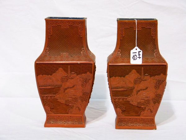 Pair Early Chinese Cinnabar Landscape Vase's: Pair Early Chinese Cinnabar Landscape Vase's. Has design of Mountians and village on one side other has Bridge and tower and trees. Both with greek key boarders. Both stand app. 11" tall and 6" wide.