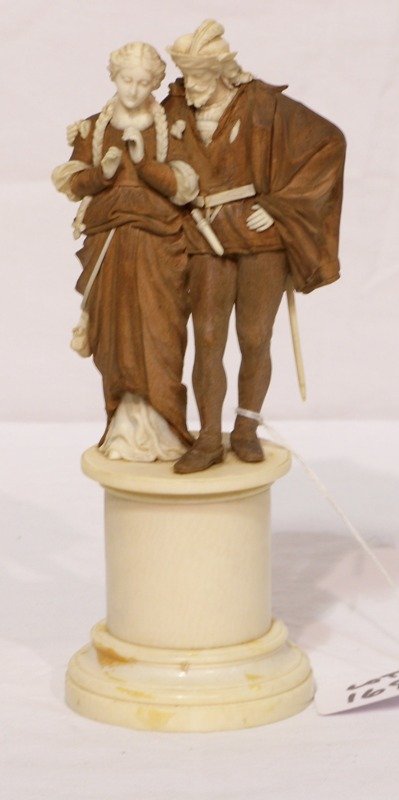 Continental Ivory & Wood Figural Grouping " Lover: Continental Ivory & Wood Figural Grouping " Lovers ". Great detail to the carvings of a man with sword on his back courting a wonderful carved young lady. Stands app. 7 3/4" tall.