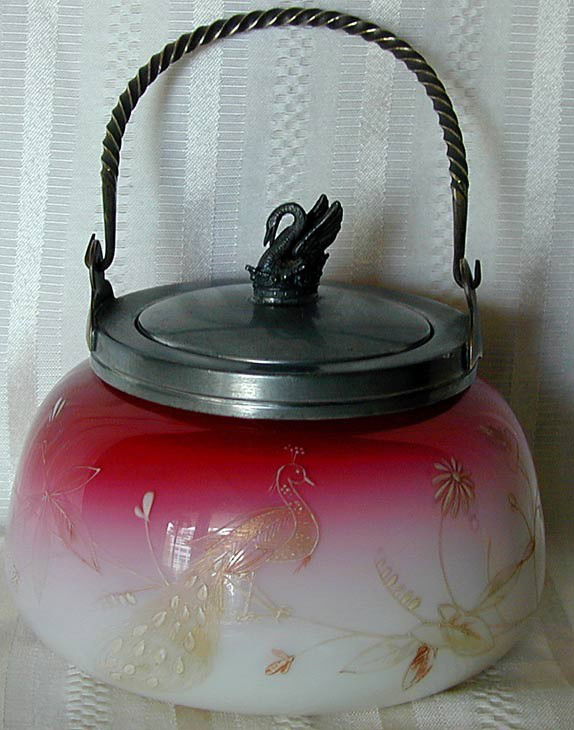 AMERICAN PLATED AMBERINA ART GLASS BOWL: A covered bowl with silverplate mounts marked Rogers Smith & Co. on inner rim - the silverplate cover has a finial designed as a swan sitting on a crown - the handle is a twisted rope design; the plat