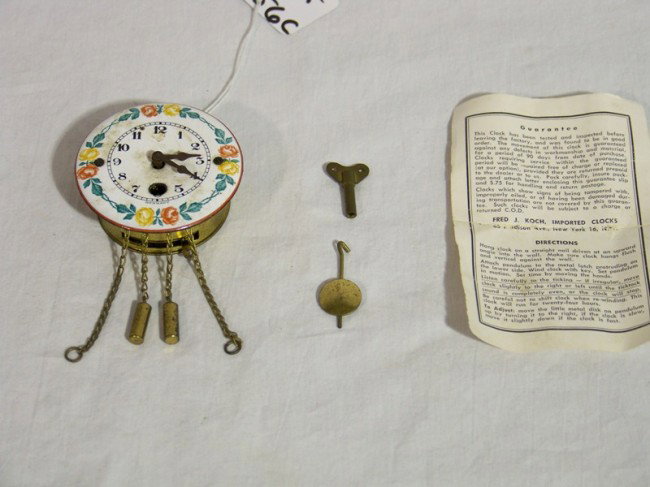 Vintage Schatz Mini Handpainted Cuckoo Clock: Vintage Schatz Mini Handpainted Cuckoo Clock. Handpainted with flowers and is 2 1/4" across. Has key and weights and original box.Non working