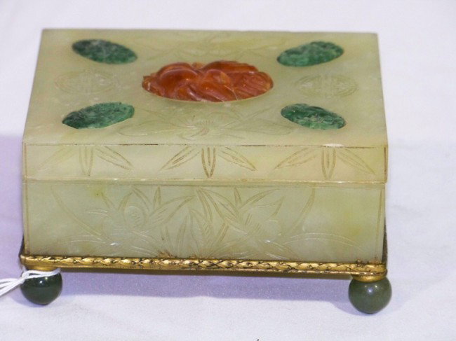 Antique Chinese Jade & Carnelian Covered Box: Antique Chinese Jade & Carnelian Covered Box, Has carving of flowers around box with symbols on top , resting on four round jade feet and resting on a bronze/brass base.4 1/4" wide 3 3/4" wide and 2 1