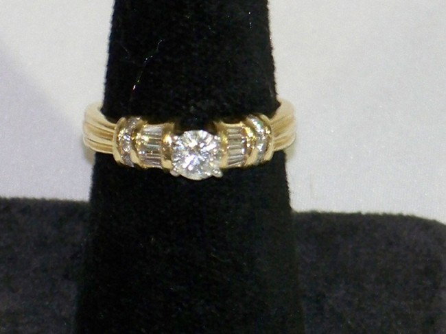 14kt & Platinum Diamond Ring : 14kt & Platinum Diamond Ring , with a modified round brilliant center diamond that is .40 ct. color G clarity l1. Set in a yellow 14kt gold band and prong set platinum and accented with round brillian