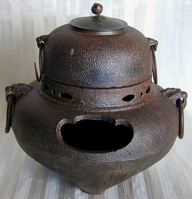 ANTIQUE JAPANESE IRON HIBACHI FURO: An antique Japanese iron hibachi or brazier furo used during tea ceremonies. 12" high x 12" wide
