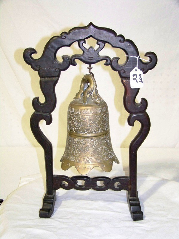 Vintage Chinesse Carved Brass Bell on Rosewood Stan: Vintage Chinesse Carved Brass Bell on Rosewood Stand. Bell si 8 1/2" tall , stand is 17" tall.Bell has no ringer.