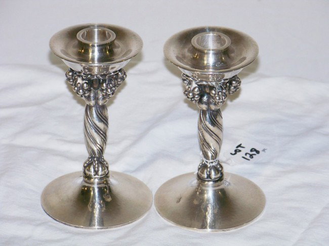 Pr Georg Jensen Denmark Sterling Candlesticks Grape: Pr. Georg Jensen Denmark Sterling Candlesticks Grapes. CANDLESTICKS. Pair of Georg Jensen sterling candlesticks with grape motif, fruit and vine decoration. Very good condition. 3.5" dia. x 6" high.