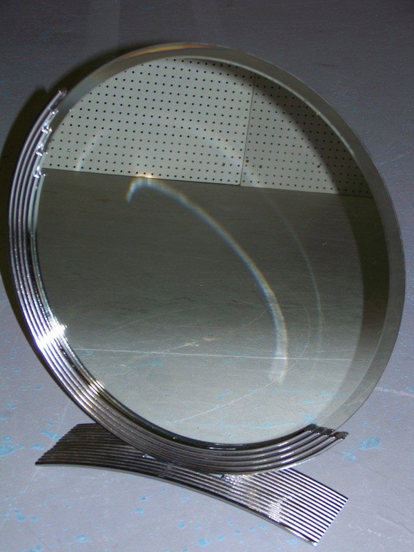 Art Deco Stainless Steel Rod Round Signed Mirror: Art Deco Stainless Steel Rod Round Signed Mirror. Monogrammed in the metal on base. Made of steel rods in a great deco style. Stands 20" tall and 18 1/2" across