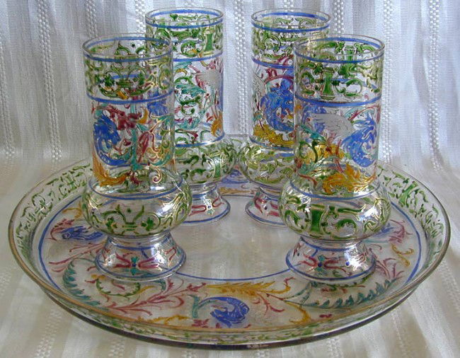 ANTIQUE MOSER ENAMELLED DRINKING SET W/ TRAY: An enamelled set of 4 antique Moser tea glasses with enamelled tray, enamelled winged dragon motif in white, pink, green, blue and gilt colors; tray measures 15"D with one chip to top rim; glasses are