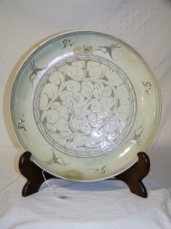 Vintage Signed 16 1/2" Celadon Flying Crane Charge: Vintage Signed 16 1/2" Celadon Flying Crane Charger. Has four flying Cranes and a vine and flowers design to center. 16 1/2" across and app. 2 1/2" deep.Has a pc. of a old paper label.