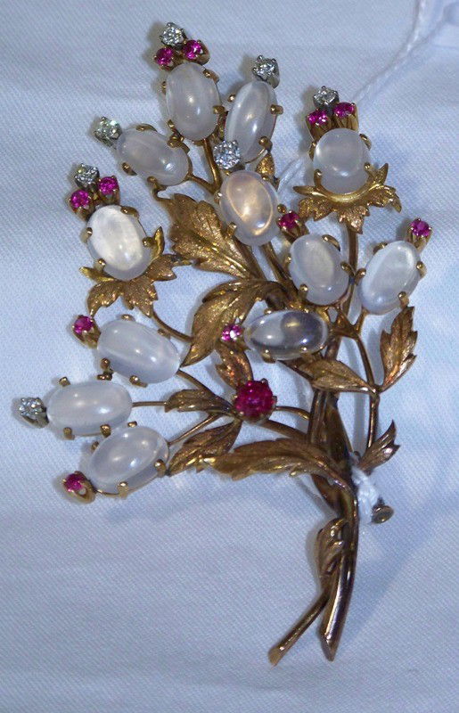 Vintage 18kt Diamond Rubies & Moonstone Floral Br: Vintage 18kt Diamond Rubies & Moonstone Floral Brooch. Description One 18 kt gold and gemstone pin. The pin is et with 7 mine cut diamonds weighing app. 2/3 carat total weight, H color ,SI 1-2 clarity