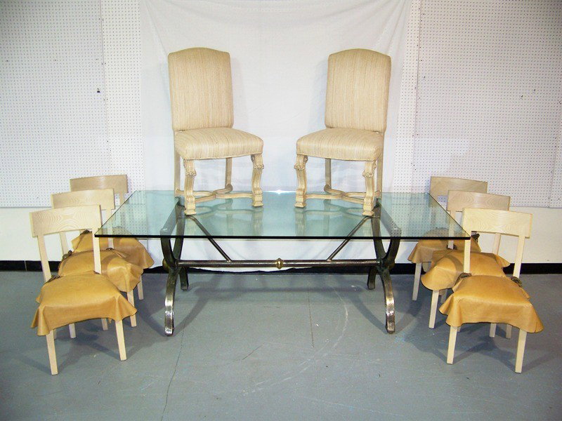 High End Modern Steel & Brass Dining Table W/ 8 C: High End Modern Steel & Brass Dining Table W/ 8 Chairs: With a 92" x 44" Glass top. Has 2 carved captians chairs and 6 wooden back side chairs.Has a great sculptured steel and brass base. Stands 30 1/
