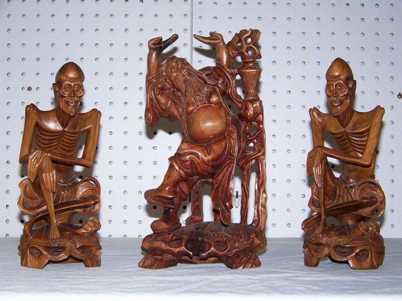 3 Vintage Wooden Carved Buddha & 2 Skeleton Guys: 3 Vintage Wooden Carved Buddha & 2 Skeleton Guys. Great carving to all three, each has ivory or bone teeth. Buddha is app. 11" tall ( with small split in base ) other two are app. 9 3/4" tall.
