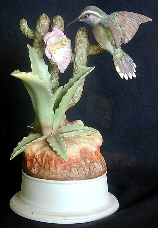BOEHM "HUMMINGBIRD & CACTUS" FIGURINE: A lovely figurine by BOEHM depicting a hummingbird by a flowering cactus plant, model # 4-40 N, Made in USA, 8.5"H, very good condition; no chips, repairs or restorations.