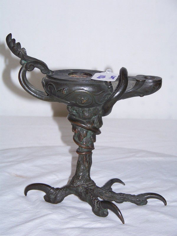 19th C. Bronze Eagle Talon & Snake Footed Oil Lamp: 19th C. Bronze Eagle Talon & Snake Footed Oil Lamp. Great early oil lamp with a large eagle talon as it foot and a snake wrapped around lamp. Stamped on base 7448 and is 8" tall and app. 8 1/2" long.