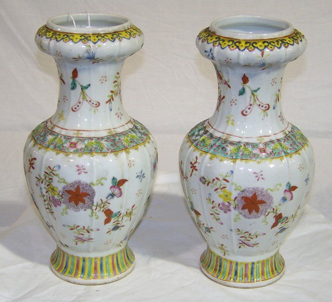 Pair Vintage Chinese Porcelain Famille Vases: Pair Vintage Chinese Porcelain Famille Rose Vases. Both app. 12" tall. Both have been drilled for use as lamps. In a round paneled shaped sides and top.