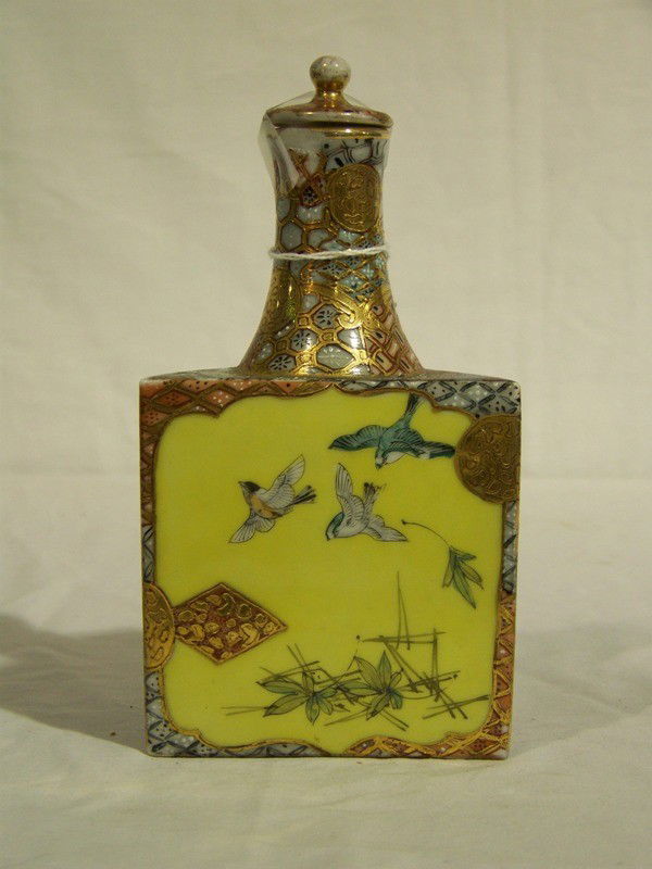Vintage Chinese Hand Painted Triangular Porc.Tea Ca: Vintage Chinese Hand Painted Triangular Porcelain Tea Caddy with stopper. Hand painted with Birds on each panel. Great gold gilt design. Stands app. 7 1/2" tall and 3 1/2" deep.