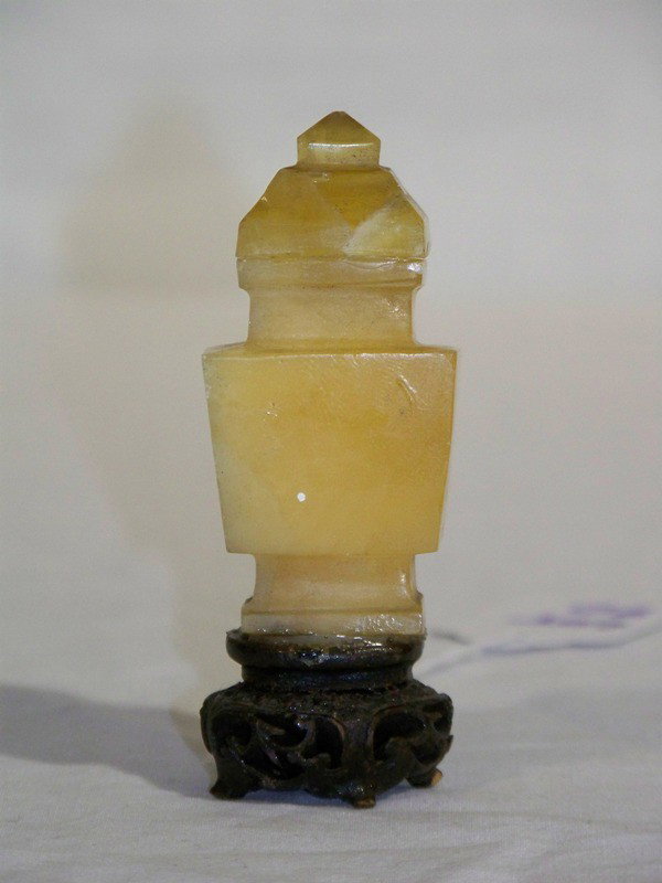 Vintage Chinese Yellow Quartz Carving of Temple Jar: Vintage Chinese Yellow Quartz Carving of Temple Jar on a very ornate carved wooden base now glued to base. Has lid and stands app. 3 1/2" tall.