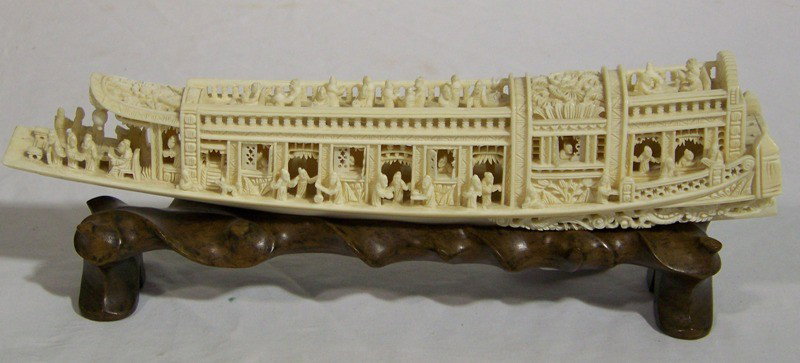 Vintage Ornate Chinese Carved Ivory of Boat on Sta: Vintage Ornate Chinese Carved Ivory of Boat on Stand. Great detailed ivory carving of a boat with many figures and flower carving, has windows that open to a figure behind each. A Great pc. that is ap