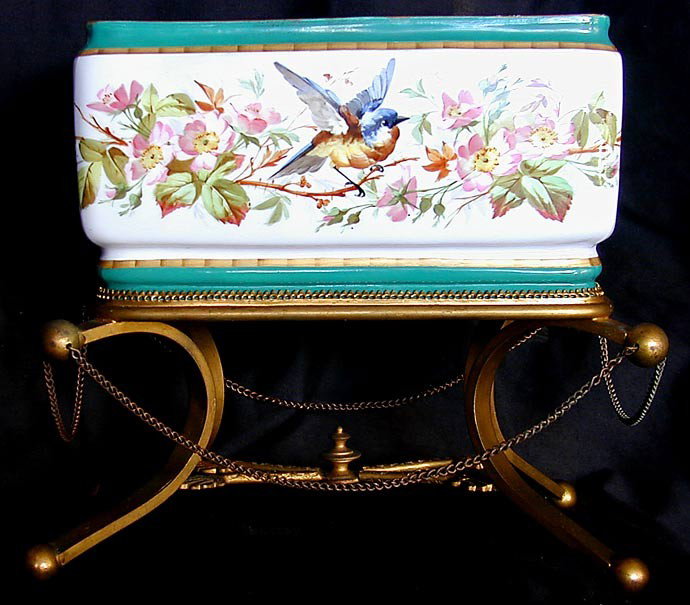 19THC OLD PARIS PORCELAIN & BRONZE JARDINIERE: A fine 19thc jardiniere with a hand-painted Old Paris decorated base mounted on a bronze dore stand with chain, 10"W x 9"H x 6"D, the rectangular bowl painted with bird and floral motifs and highlight