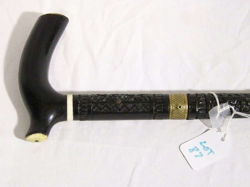 Great Antique Pierced Carved Walking Stick w/ Sword: Great Antique Pierced Carved Walking Stick w/ Sword. Has carving at top and on base also has a Ivory or Bone inlaid on shaft and top oh handle.Has a brass slide lock switch. Sword is app. 31 1/2" long
