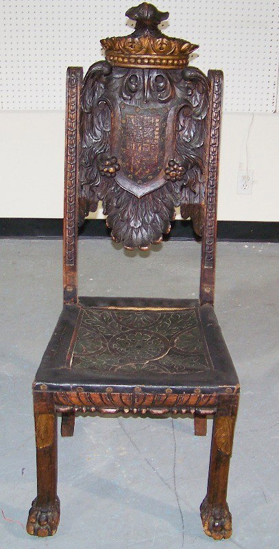 18 C. Italian Kings Crown & Eagle Carved Chair: 18 C. Italian Kings Crown & Eagle Carved Chair. Has a tooled leather seat with damage and a great leather shield to center of chair with eagle claw carvings to hold shield with eagle feathers at base.