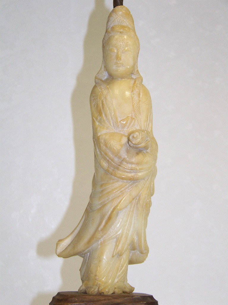 Antique Chinese Soapstone Carving of Quan Yin: Antique Chinese Soapstone Carving of Quan Yin. Resting on a wooden base, now attached to a Chinese bronze base with Greek key borders and symbols now mounted as lamp. Soapstone carving stands 10" tall