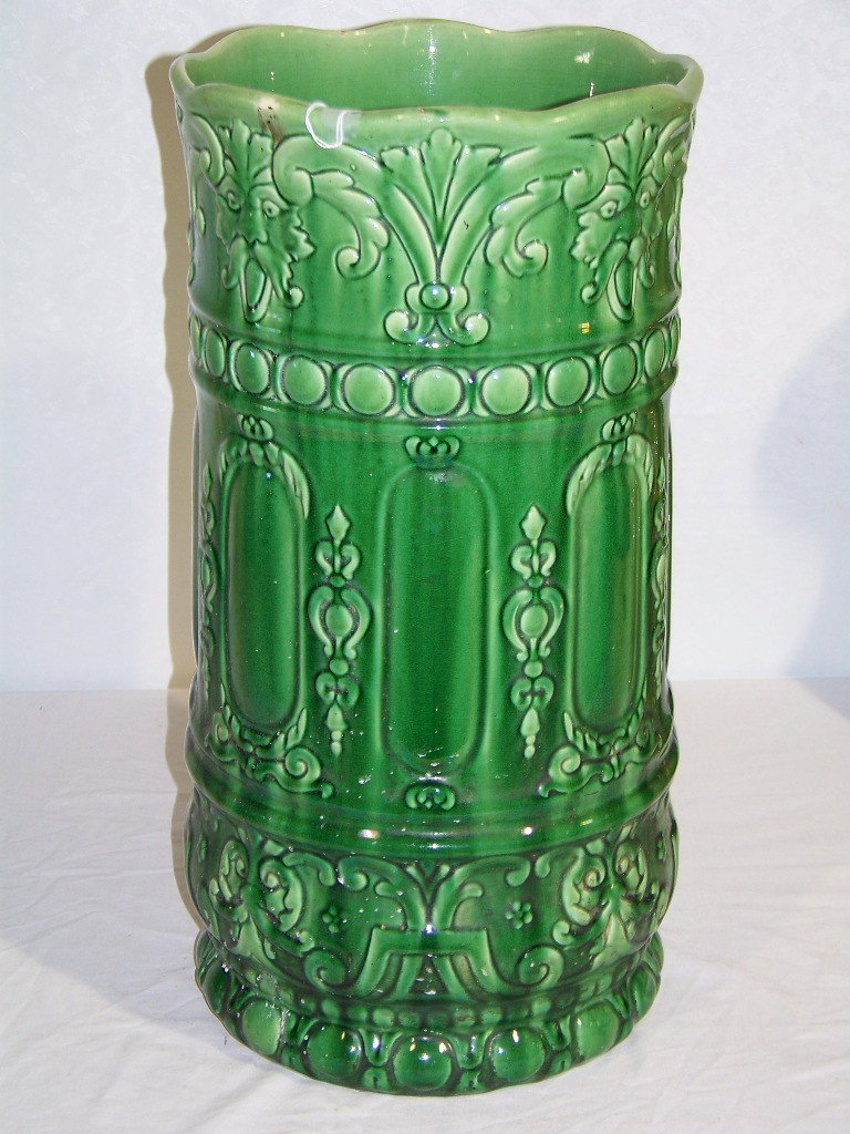 Vintage Signed Weller Umbrella Stand: Vintage Signed Weller Umbrella Stand in a green glaze with figures at top. Stands 20.5" tall x 10.5" wide.