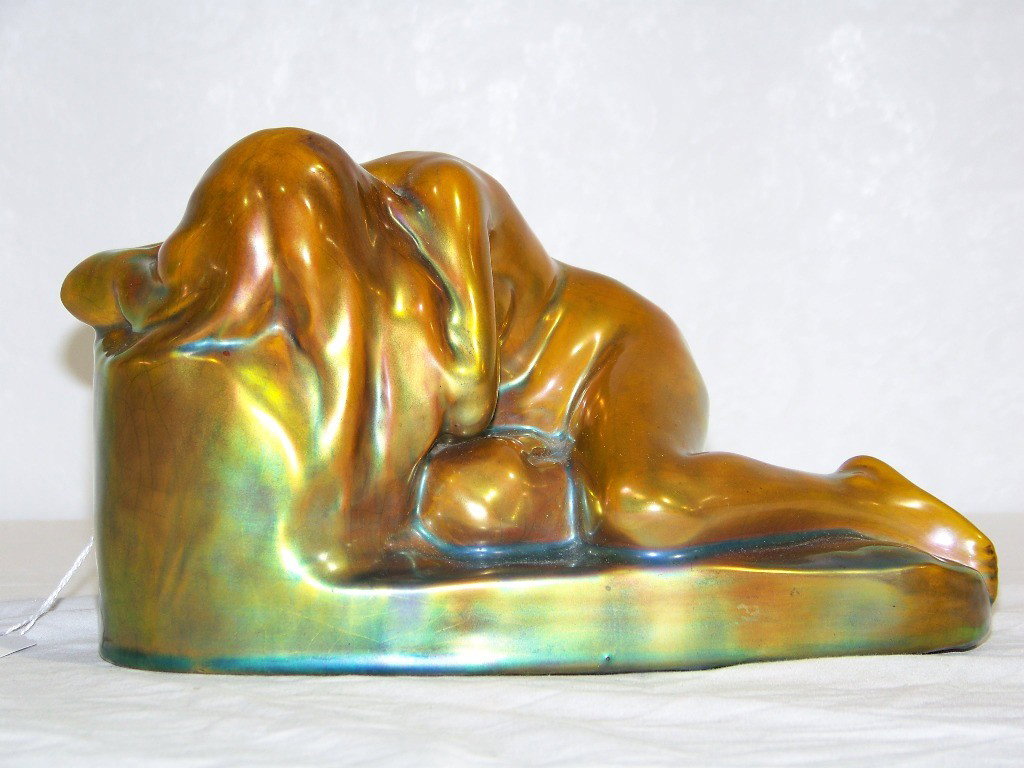 Antique Zsolnay Pecs Porcelain Coppertone Nude Fig: Antique Zsolnay Pecs Porcelain Coppertone Nude Figure. Great figure of a young lady resting on a rock.Date number is for 1906-1910 stamped on base.Figure is app.6" tall,9 1/2" long and app. 5" deep. D