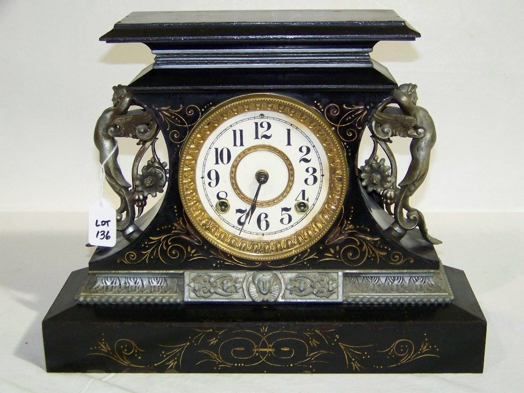 Antique Figural Ansonia Mantle Clock: Antique Figural Ansonia Mantle Clock. Great old clock with winged Cherubs on sides in a metal case. Clock is app.12" tall,15 1/2" wide.Works good with key.