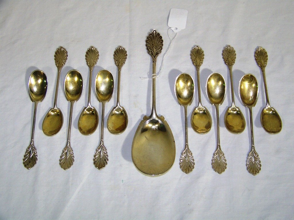 19th C. 13 pc. Set of Ornate Coin Silver Spoons wi: 19th C. 13 pc. Set of Ornate Coin Silver Spoons all with a slight gold wash to bowls of spoons. Set has one large 9 1/4" Ice Cream Shovel/Pie Server and 12 - 5 3/4" spoons.Monogrammed on backs.Total w