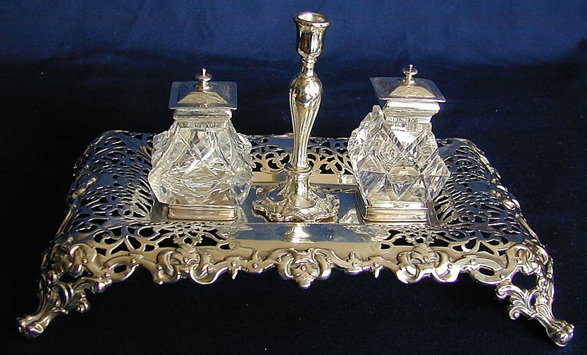 STERLING SILVER INKSTAND HW&Co SHEFFIELD 1866: A sterling silver inkstand designed by Henry Wilkinson & Co, Sheffield, England, date hallmark for 1866-7, the pierced rectangular base on lion paw feet with removable center pen holder designed as a 