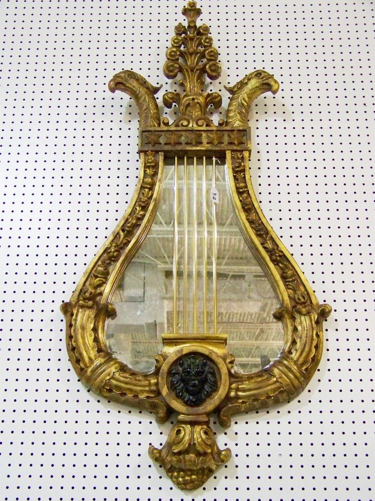 Fine Gilt Ornate Eagle Head Mirror "Hilda Flack": Fine Gilt Ornate Eagle Head Mount Mirror "Hilda Flack". Great mirror in a Lyre form Stars,and Eagle head figures to top with a Lion head mount to center.Mirror is app.54" tall and app.27" wide.Has a H