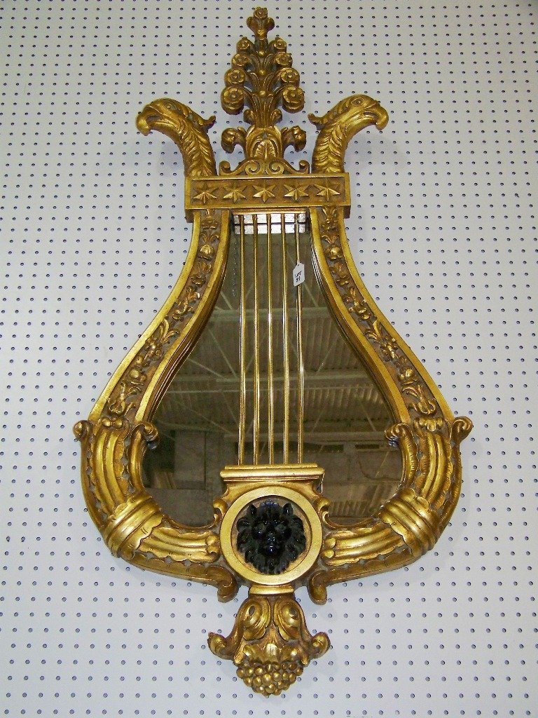 Fine Gilt Ornate Eagle Head Mount Mirror "Hilda Fla: Fine Gilt Ornate Eagle Head Mount Mirror "Hilda Flack". Great mirror in a Lyre form Stars,and Eagle head figures to top with a Lion head mount to center.Mirror is app.54" tall and app.27" wide.Same as