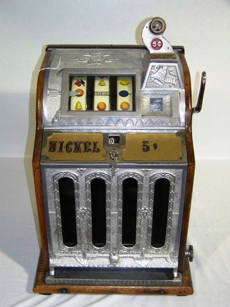 Great Mills Novelty Bicentennial Nickel Slot Machi: Great Mills Novelty Bicentennial Nickel Slot Machine. Great all original working slot machine with a oak case and metal fronts. Has a Owl on top and a 1776 Bell by coin drop.App.26" tall,14 1/4" wide