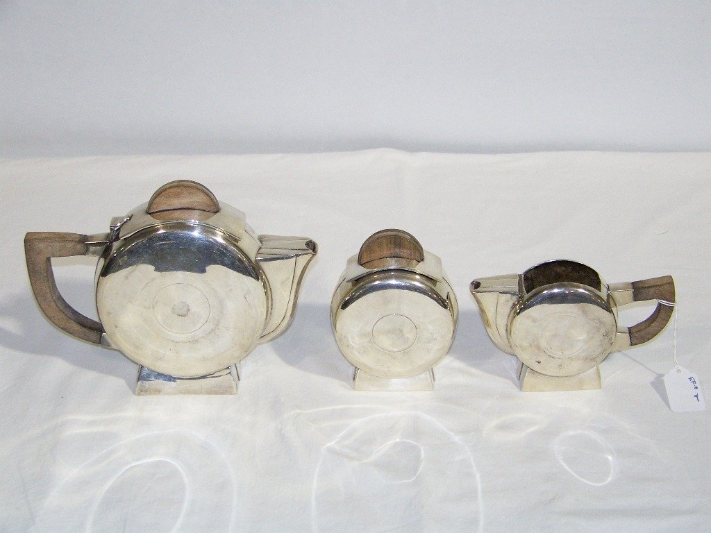 3 Pc. Art Deco Silver Tea Set: 3 Pc. Art Deco Silver Tea Set.Great silver plate Art Deco Style partial tea set with a 7" tall tea pot a 5 1/2" lidded sugar bowl and creamer. Each has wooden handles.