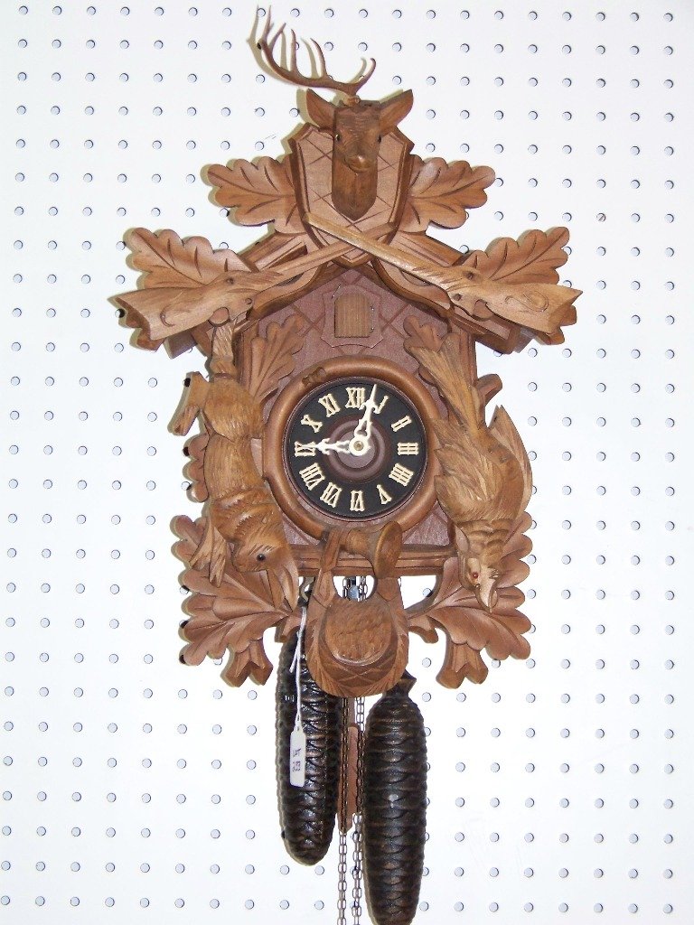 Vintage Black Forest Cuckoo Clock: Vintage Black Forest Cuckoo Clock, with birds and a one horned Deer at top.Clock is app.16" tall and app.13" wide and app. 12" deep.Birds have glass eyes and has a rifle at top with the Deer.