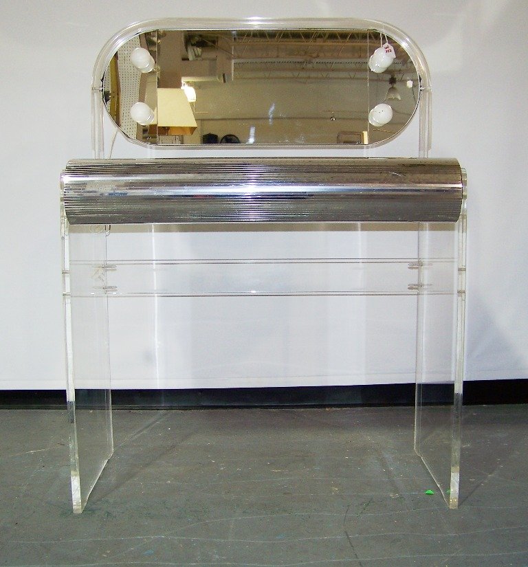 Mid Century Modern Lucite Vanity w/Swing Mirror: Mid Century Modern Lucite Vanity w/Swing Mirror. Great vanity with thick Lucite legs and around mirror. Has 4 lights and has a mirrored top ( with crack as shown).Stands app.43" tall,32" wide an d 19"