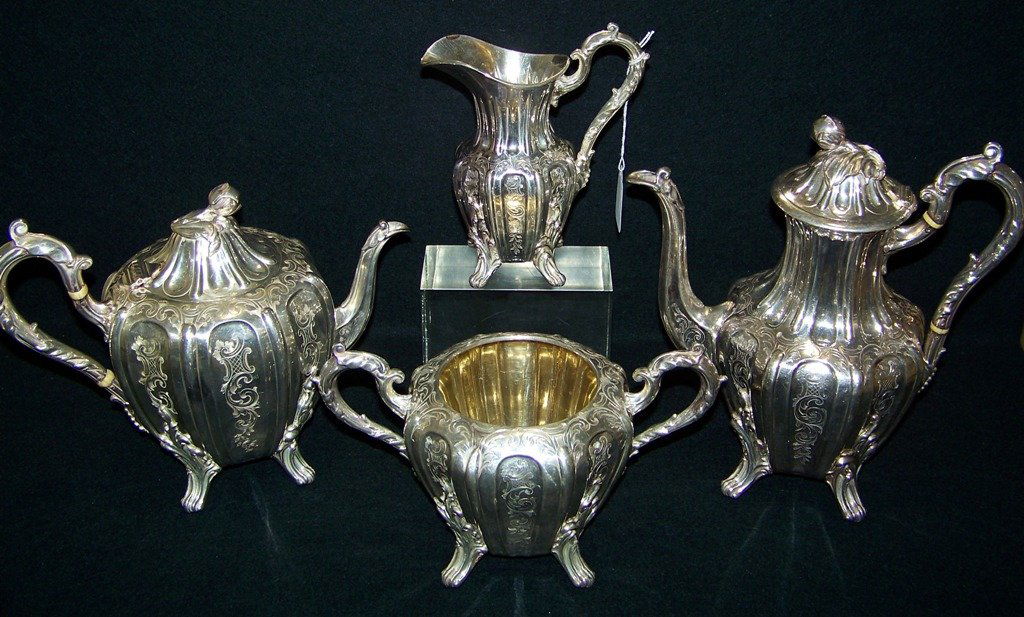 Great 19th C.4 Pc. Ornate Mellon Shaped Silver Tea Set: Great 19th C.4 Pc. Ornate Silver Tea Set. Great four pc. set with a very nice scroll design with a flower bud finials. Set has a 11" tea pot, a 8 1/2" Coffe, and creamer and sugar.Hallmarked on bottom