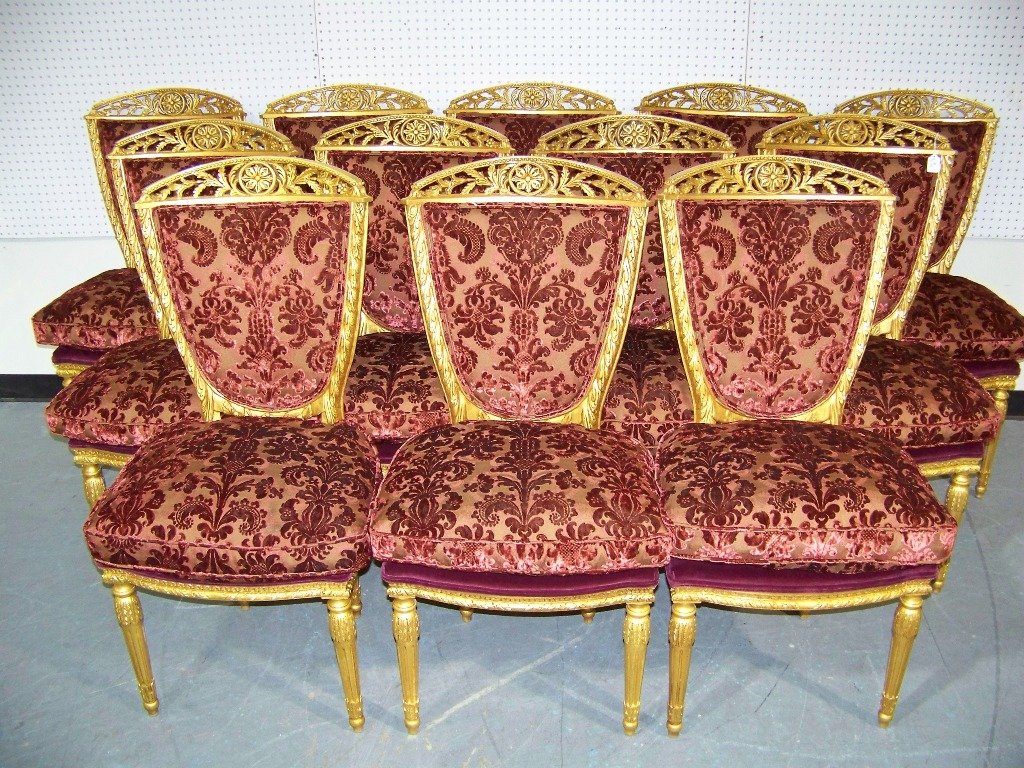 12 Killer French Carved Ornate Gilded Chairs: 12 Killer French Carved Ornate Gilded Chairs.Great ornate carving throughout each in a fine red baroque fabric.Solid wood upholstered seats with a down filled seat cushion to each.Each is app.3'6" tal