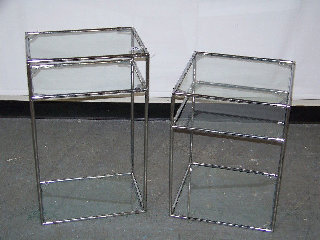 Pair of Mid C. Modern Chrome Stands / Tables: Pair of Mid C. Modern Chrome Stands / Tables.Taller stand is app.26 1/2" tall and app.16" wide and 11" deep.Smaller one is app.21 1/2" tall and 16" wide and deep.Each with three glass shelves each.