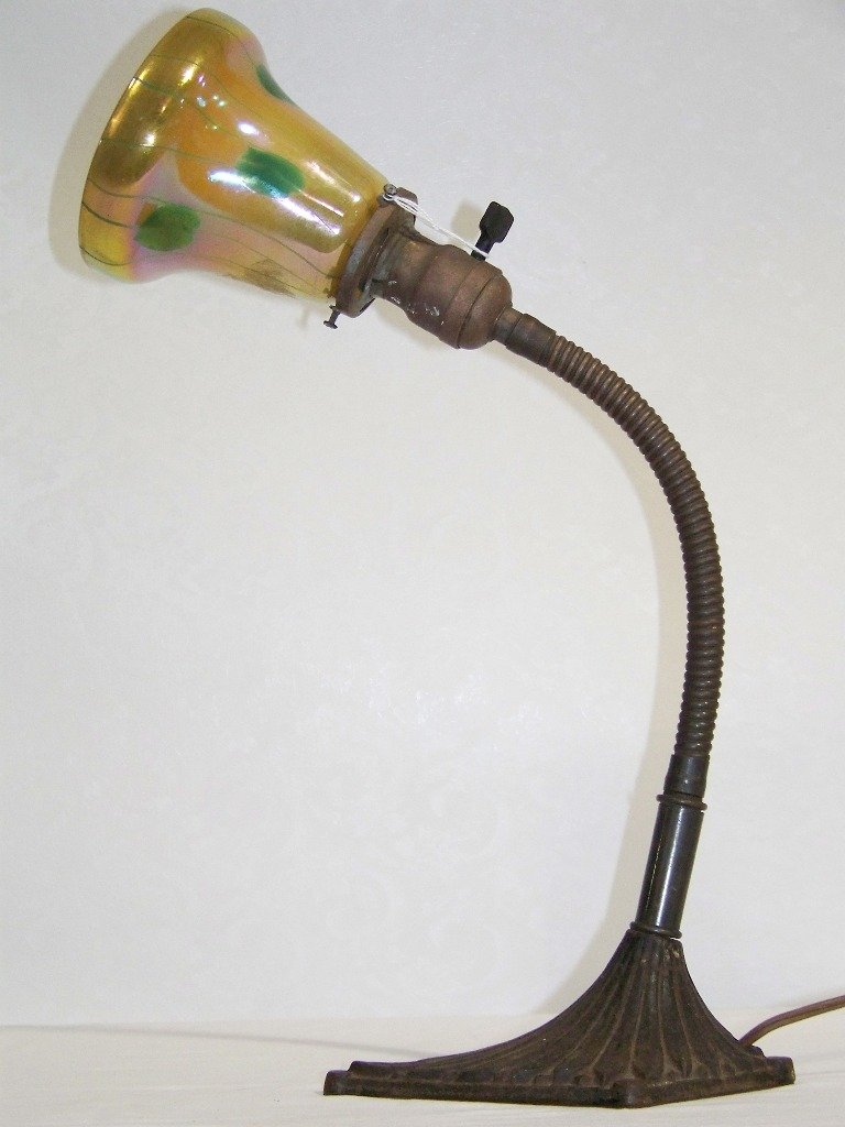 Tiffany Studios Desk Lamp with LCT Favrile Shade: Tiffany Studios Desk Lamp # 3257. Great desk lamp with a signed LCT Favrile art glass shade.Lamp has a neck that adjusts to any position.Shade is app.4 5/8" long.( Shade has a glass imperfection at so