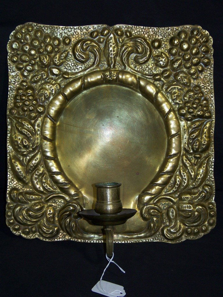 19th C. Hammered Brass Sconce: 19th C. Hammered Brass Sconce with a flower design.Single candle an is app.12 1/4" tall,11 3/4" wide.