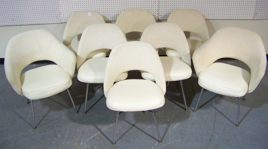 8 Mid Century Eero Saarinen by Knoll Upholstered Chairs: Set of eight Mid Century Eero Saarinen by Knoll upholstered chairs. Includes two arm chairs.Chairs have a material back and vinyl seats.Each is app.32" tall,24" deep and 26 1/2" wide.