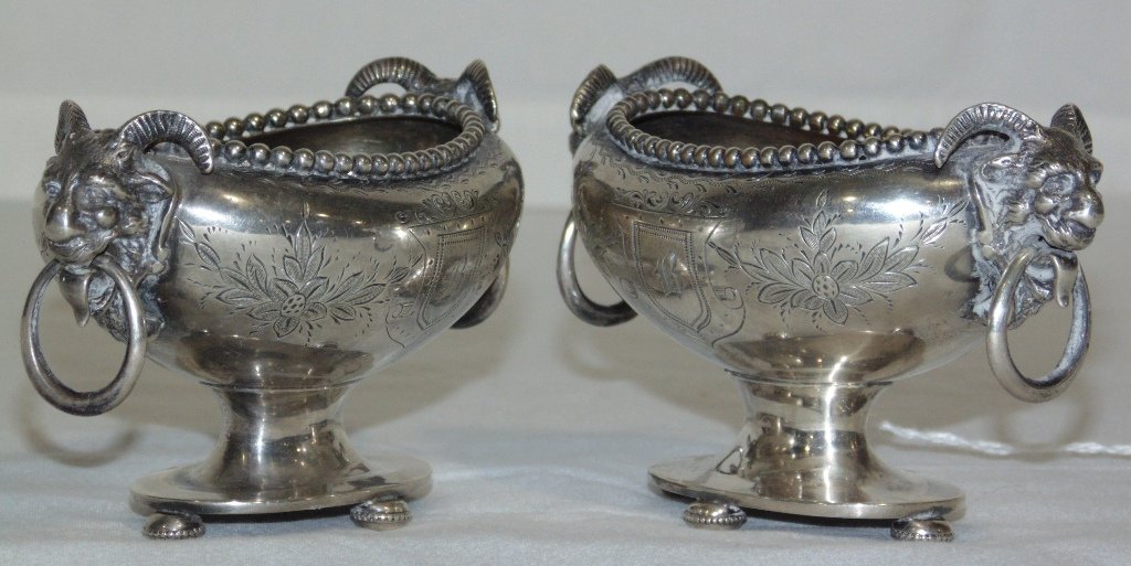 Pair 19th C. Sterling Ram's Head Mount Salt Cellars: Pair 19th C. Sterling Ram's Head Mount Salt Cellars. A great pair each with Ram's head with ring handles to each.Each has floral pierced carving with a crest to each side.One crest to each is monogram